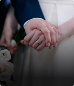 Couple holding hands during a wedding ceremony